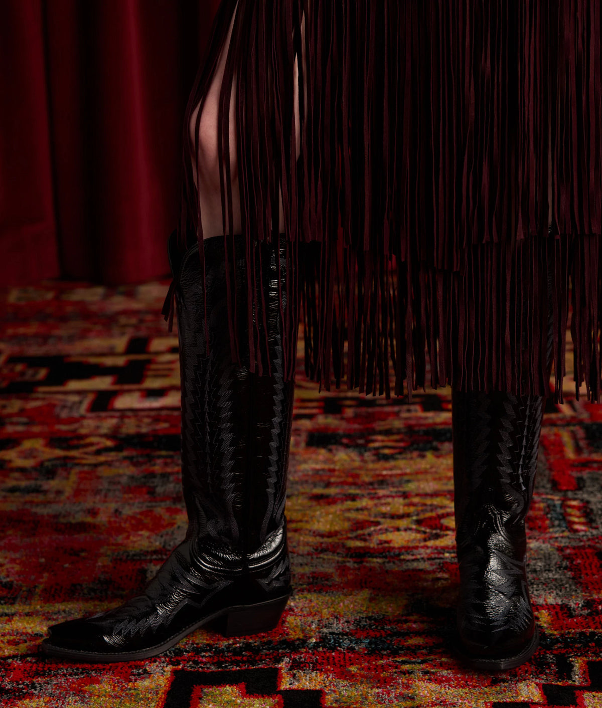 Priscilla Crinkle Patent Black — seated boot detail, crinkle texture 12